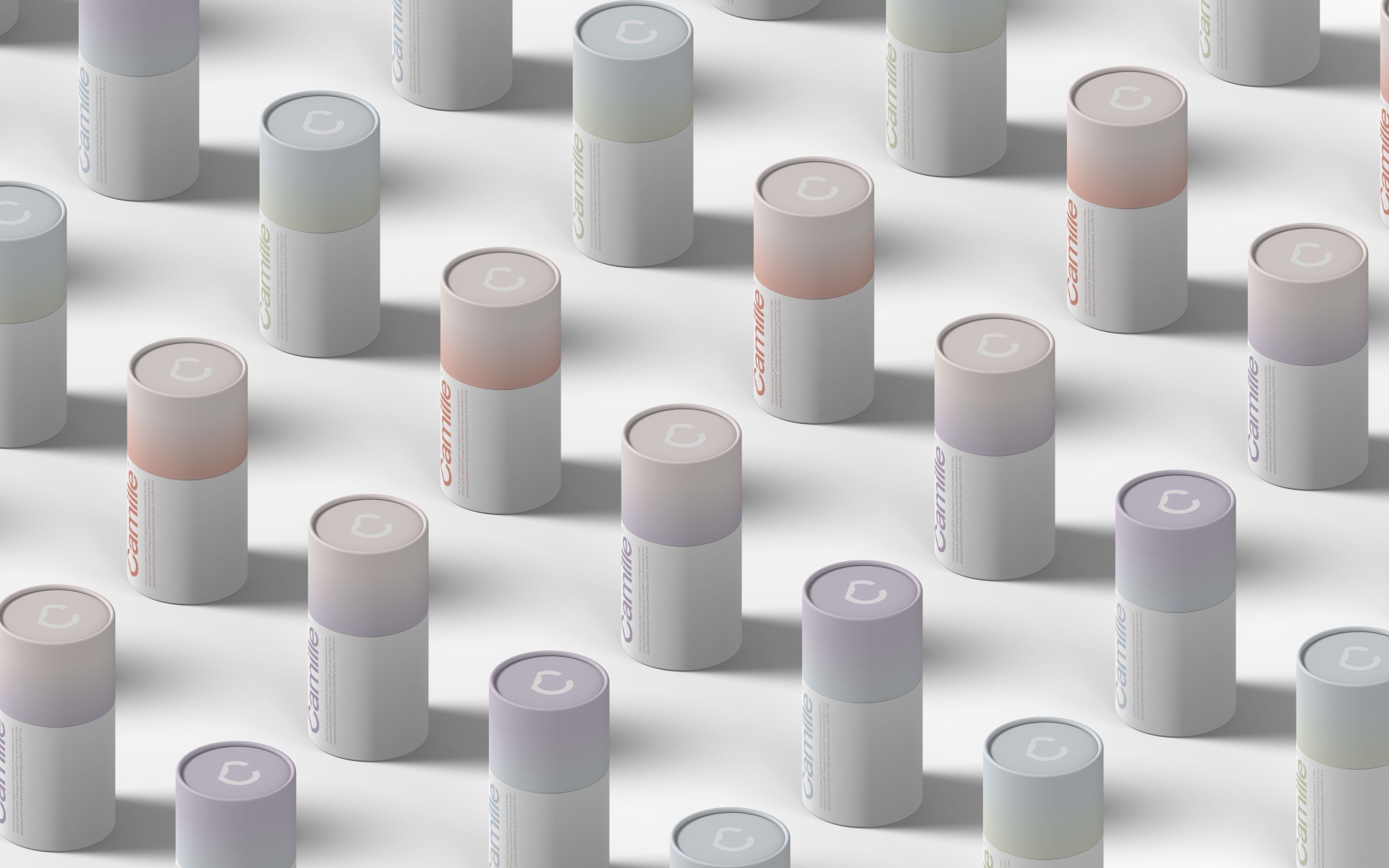 A grid of pastel-colored cylindrical boxes showcasing the range of Camille interchangeable mattress covers