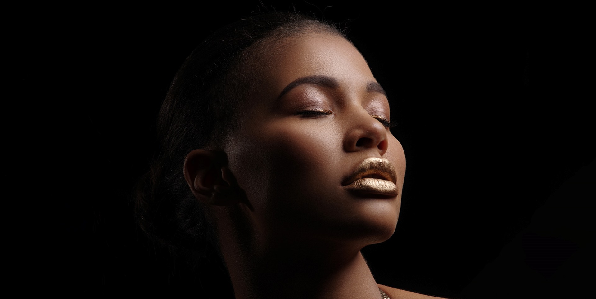 A woman with closed eyes and shimmering golden makeup against a dark background,  exuding high-end elegance and luxury