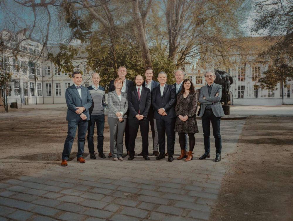 BekaertDeslee's executive committee standing in front of a tree and white building