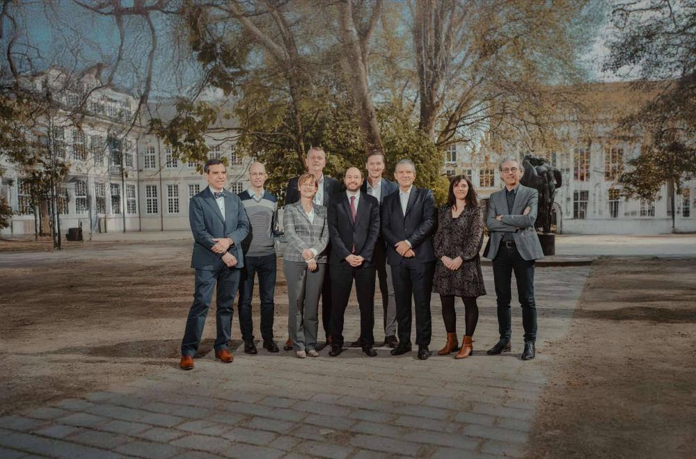 BekaertDeslee's executive committee standing in front of a tree and white building